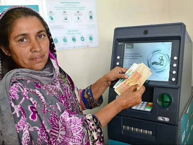 BISP beneficiary withdrawing Rs.13,500 payment from biometric ATM