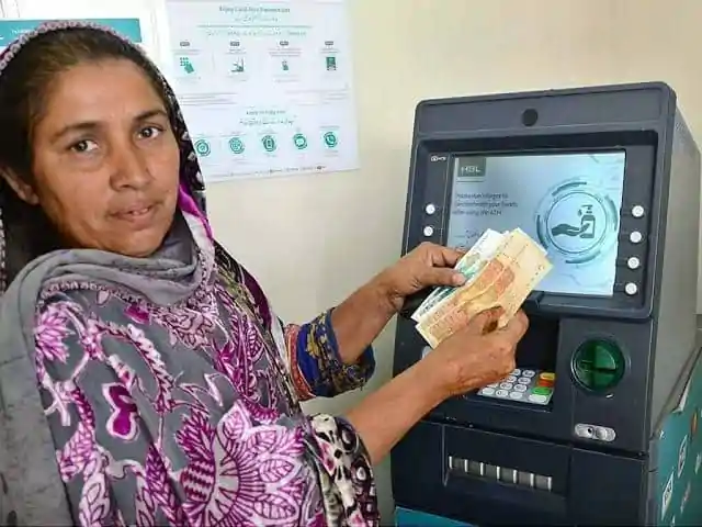 BISP beneficiary withdrawing Rs.13,500 payment from biometric ATM
